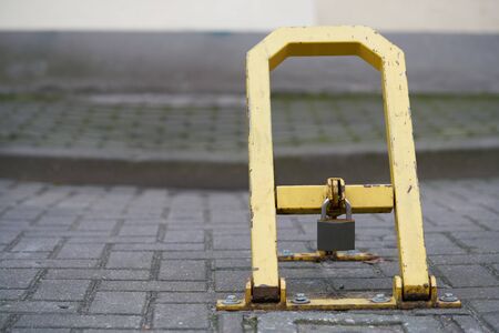 Manual car parking barrier with lock and stop sign. Car parking lock device. Dedicated parking for...