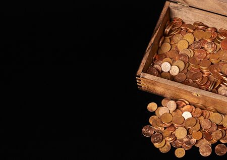 Euro coins in chest on black backgrtound. View from top.の写真素材