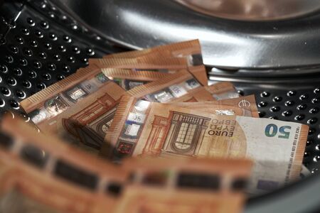 Money in washing machine, closeup view.の写真素材