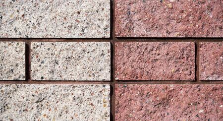 Yellow and pink bricks wall. Bricks texure. Brick background.の写真素材