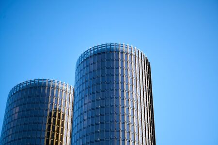 A skyscraper against a blue sky with clouds.