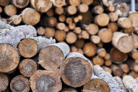 Natural wooden background - closeup of chopped firewood. Firewood stacked and prepared for winter...