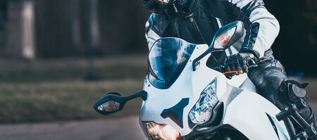 young man riding big bike motorcycle leaning curve on asphalt highways road.の写真素材
