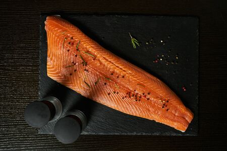 fresh raw salmon on stone cutting board