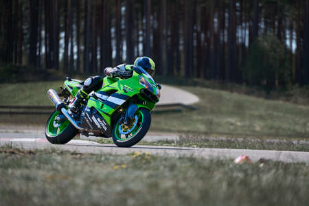 10-05-2020 Ropazi, Latvia Motorcyclist at sport bike rides by empty asphalt road. sport bike.