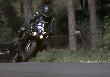 11-05-2020 Riga, Latvia Motorcyclist at sport bike rides by empty asphalt road. sport bike.のeditorial素材