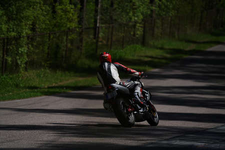 11-05-2020 Riga, Latvia Motorcyclist at sport bike rides by empty asphalt road. sport bike.