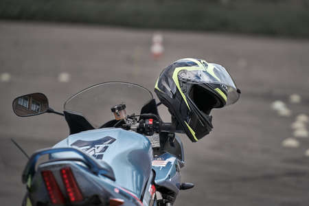 25-05-2020 Riga, Latvia. Motorcyclist goes on road, front view, closeup.