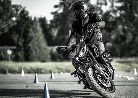 11-05-2020 Riga, Latvia. man on a motorbike on the road riding. having fun driving the empty road on a motorcycle tour journeyのeditorial素材