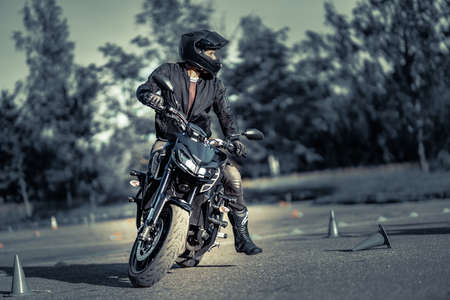 11-05-2020 Riga, Latvia. man on a motorbike on the road riding. having fun driving the empty road on a motorcycle tour journeyのeditorial素材
