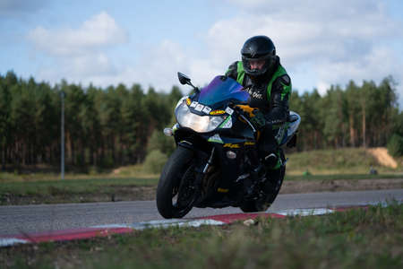 10-05-2020 Ropazi, Latvia Motorcyclist at sport bike rides by empty asphalt road. sport bike.