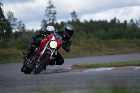 09/19/2020 Riga Latvia Handsome motorcyclist in black riding his super sport motorcycle