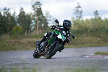 09/19/2020 Riga Latvia Handsome motorcyclist in black riding his super sport motorcycle