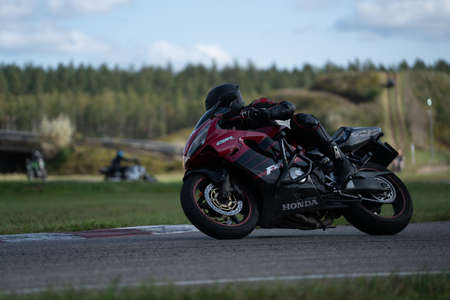 09/19/2020 Riga Latvia Handsome motorcyclist in black riding his super sport motorcycle