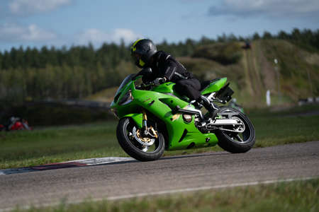 09/19/2020 Riga Latvia Handsome motorcyclist in black riding his super sport motorcycle