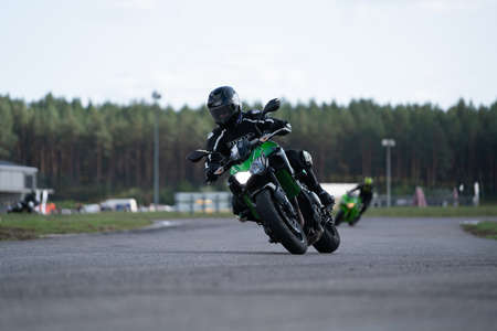 09/19/2020 Riga Latvia Handsome motorcyclist in black riding his super sport motorcycle