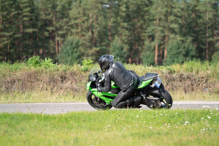05-09-2020 Riga, Latvia Man on a motorbike on the road riding. having fun driving the empty road on...