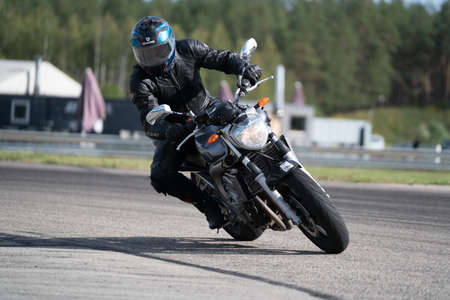 10-06-2020 Riga Latvia Motorcycle practice leaning into a fast corner on track.
