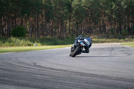10-09-2020 Ropazi, Latvia Motorcyclist at sport bike rides by empty asphalt road. sport bike....