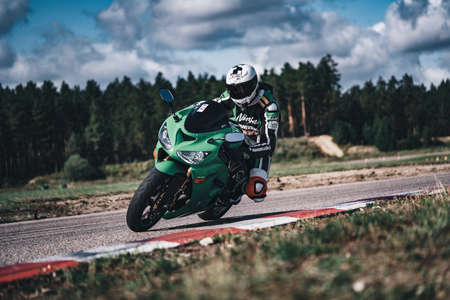 05-09-2020 Riga, Latvia Man on a motorbike on the road riding. having fun driving the empty road on a motorcycle tour journey. copyspace for your individual textのeditorial素材