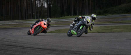 man riding motorcycle in asphalt road. Motorcyclist at black and white sport motorcycle.