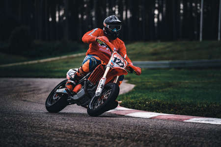 05-09-2020 Riga, Latvia Man on a motorbike on the road riding. having fun driving the empty road on a motorcycle tour journey. copyspace for your individual text.のeditorial素材