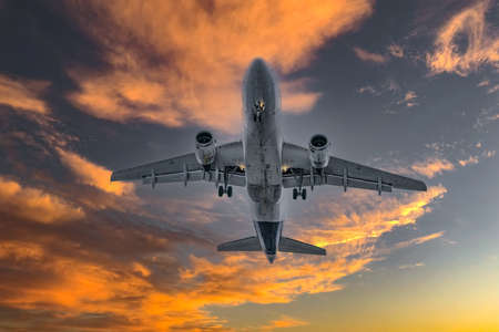 Airplane in the sky at sunrise or sunsetの写真素材