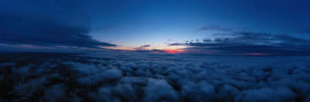 evening sunset sky panorama with some clouds. Panorama over clouds.