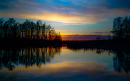 sunset at coast of the lakeの写真素材