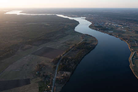 Top view of the Seim River (Ukraine), surrounded by trees and meadows on its banks, view from the...