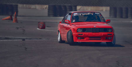 01-05-2021 Riga Latvia Side view of cherry red sedan parkedのeditorial素材