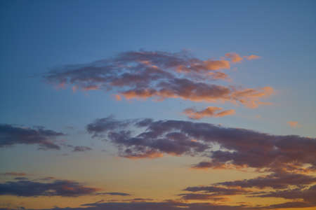 Dramatic sunset sky with orange colored clouds.