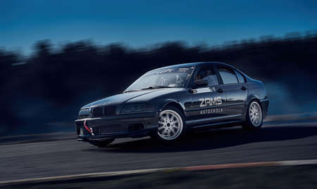 Blurred car drifting, motion blur car drift with whit smoke on race track.