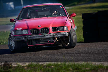 Blurred car drifting, motion blur car drift with whit smoke on race track.