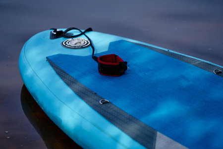 Close-up of a blue paddle board with a ring on it.