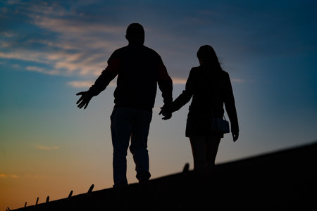 Man and woman love silhouette in sunset.の写真素材