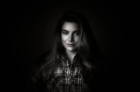 Beautiful woman face close up portrait young studio on grey. Black and white woman portrait.の写真素材