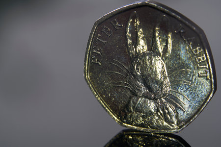 A closeup shot of a silver coin with a golden eagle on itの写真素材