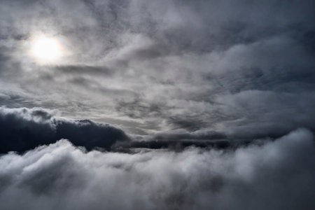 Dark clouds and sun in the sky. dramatic cloudscape.の写真素材