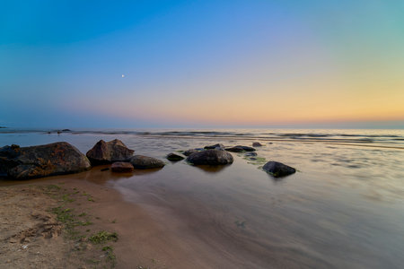 Sea waves lash line impact rock on the beachの写真素材