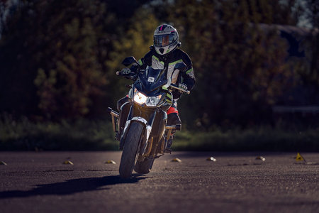 19-09-2021 Riga, Latvia A young man riding a motorcycle on an open road.