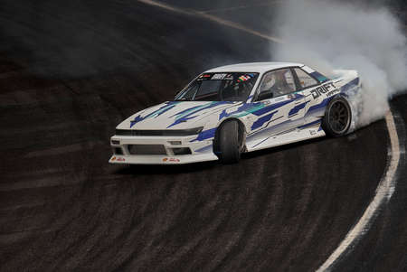 11-05-2022 Riga, Latvia car drifting on asphalt racing track with lot of smoke, motion blur drift...