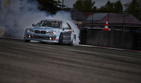 11-05-2022 Riga, Latvia car drifting on asphalt racing track with lot of smoke, motion blur drift...