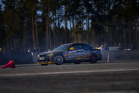 11-05-2022 Riga, Latvia car drifting on asphalt racing track with lot of smoke, motion blur drift...