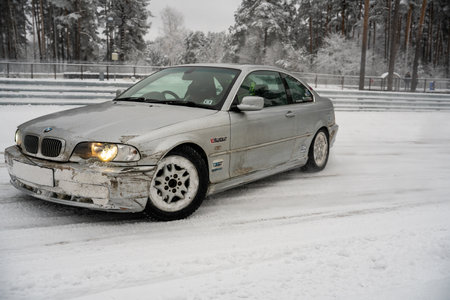 12-12-2022 Riga, Latvia a car that is sitting in the snow with its hood up and headlight on and it is broken. .のeditorial素材