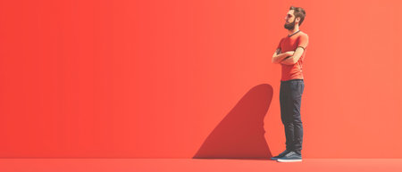 Man in orange t-shirt with crossed arms on red background. 3d renderingの素材