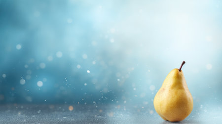Yellow pear on a blue background with bokeh and copy spaceの素材