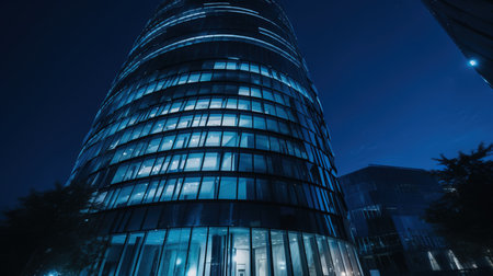 Modern office building at night. Architectural detail of modern building.の素材