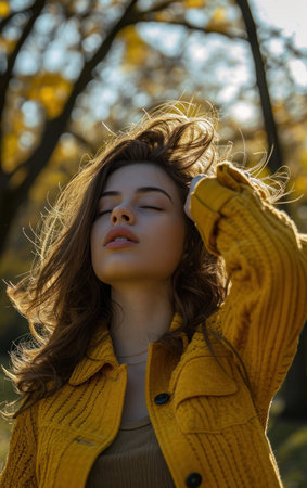 Portrait of a beautiful young brunette girl in a yellow coatの素材