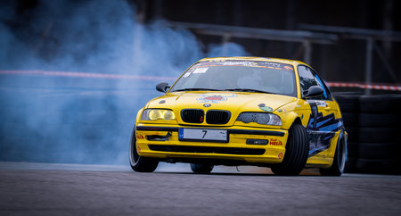 Latvia, Riga 03-05.10.2025. FIA Drifting cup. A yellow car with a lot of smoke coming out of it. .